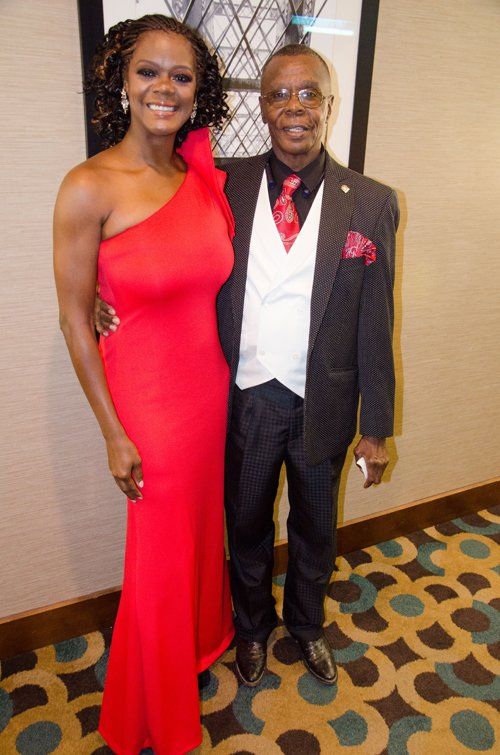 man in tuxedo and girl in red dress