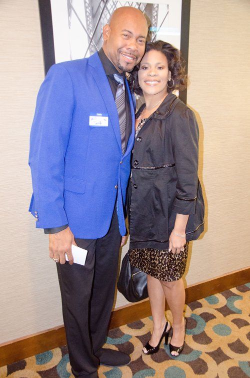 man in blue suit and woman in black dress