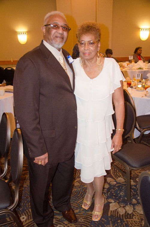 man in brown tuxedo and woman in white dress