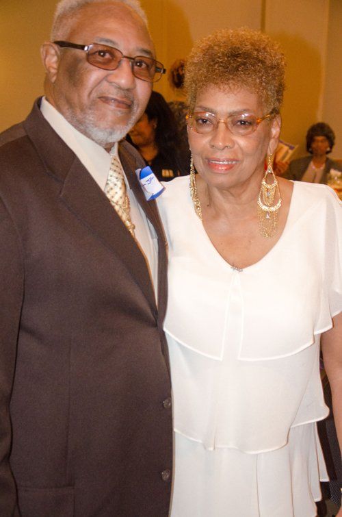man in brown tuxedo and woman in white dress