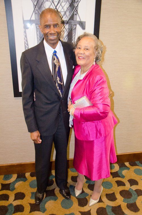 man in tuxedo and woman in pink dress