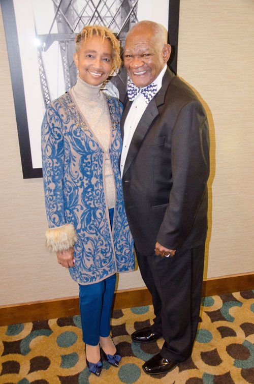 man in tuxedo and woman ask color dress