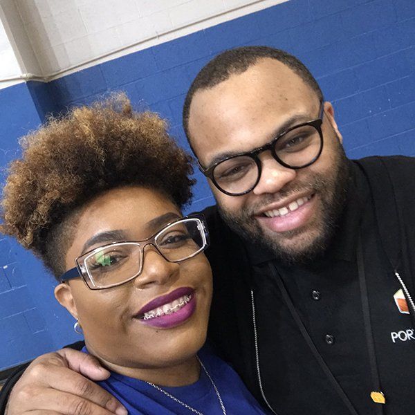 man in black dress and semi afro girl