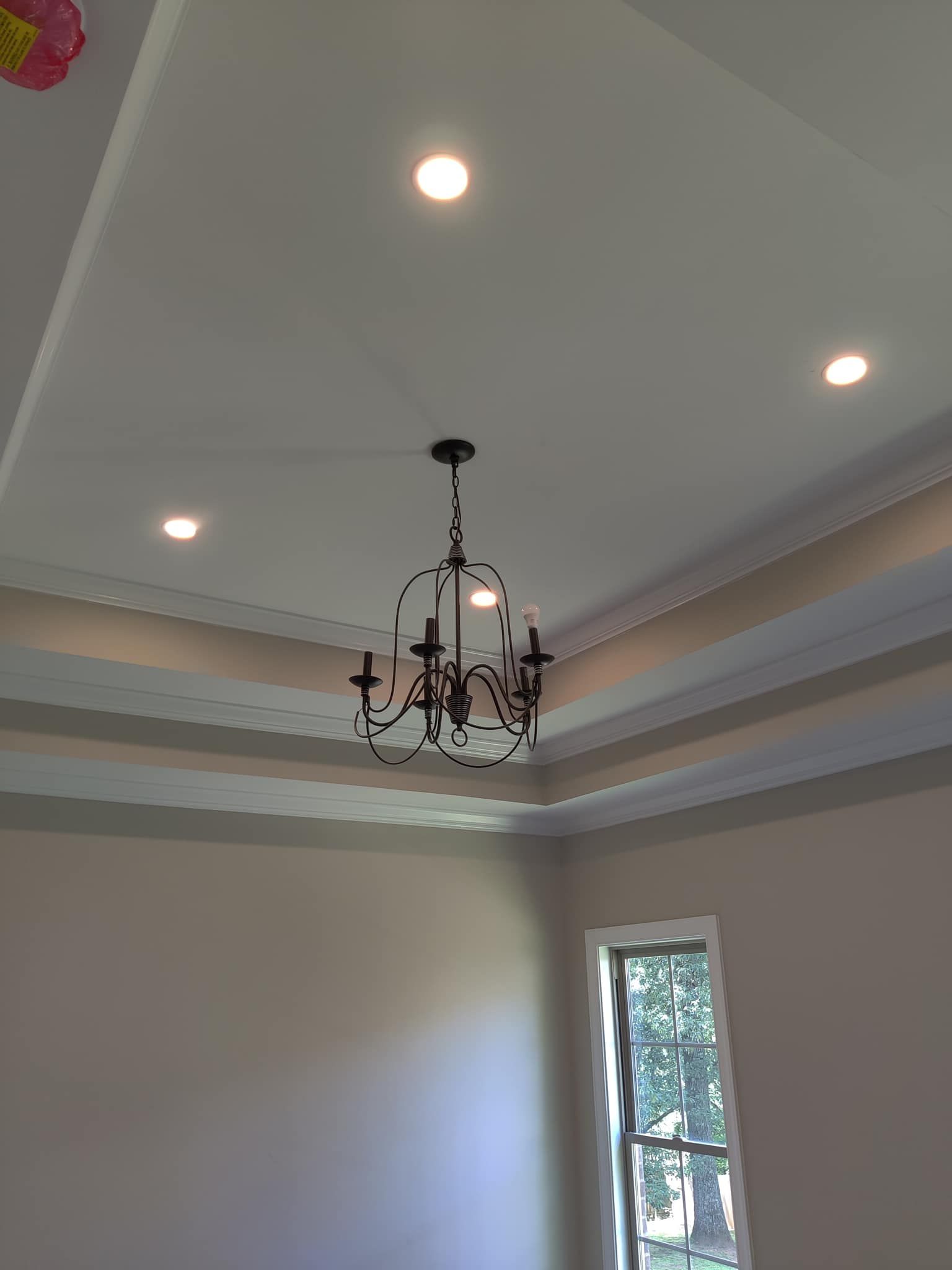 A chandelier is hanging from the ceiling of a room.