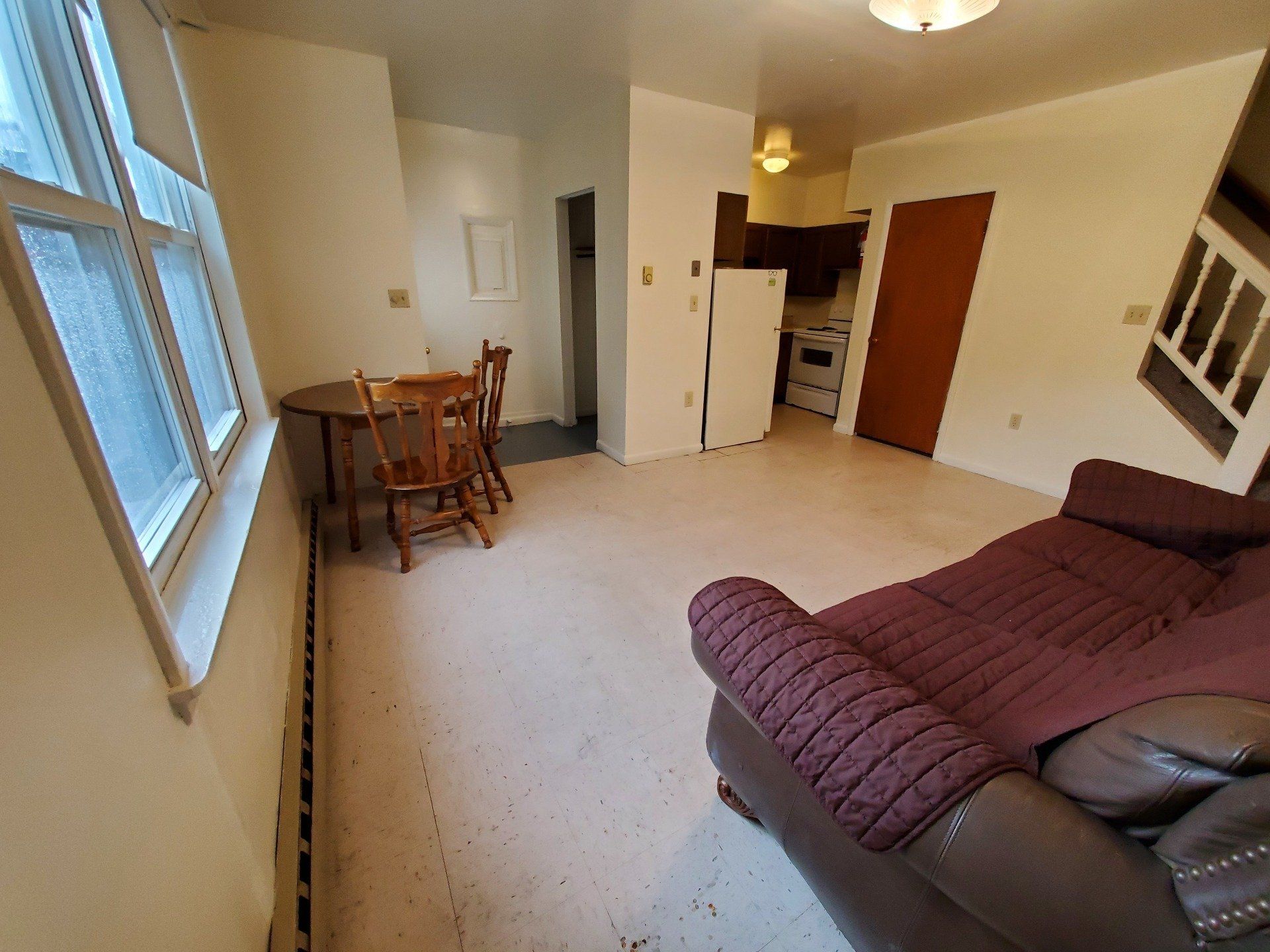 Living room with table and view of kitchen