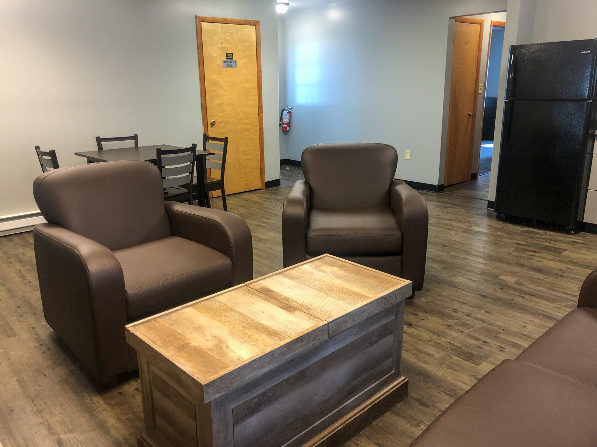 Living room with couch, chairs and view of kitchen