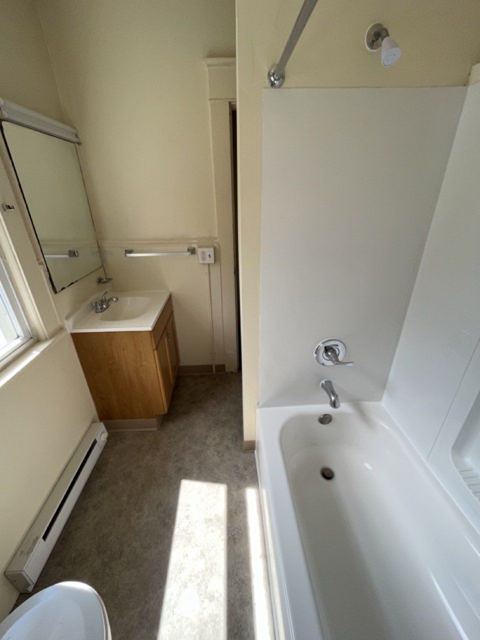 Bathroom with sink, toilet, and tub with shower