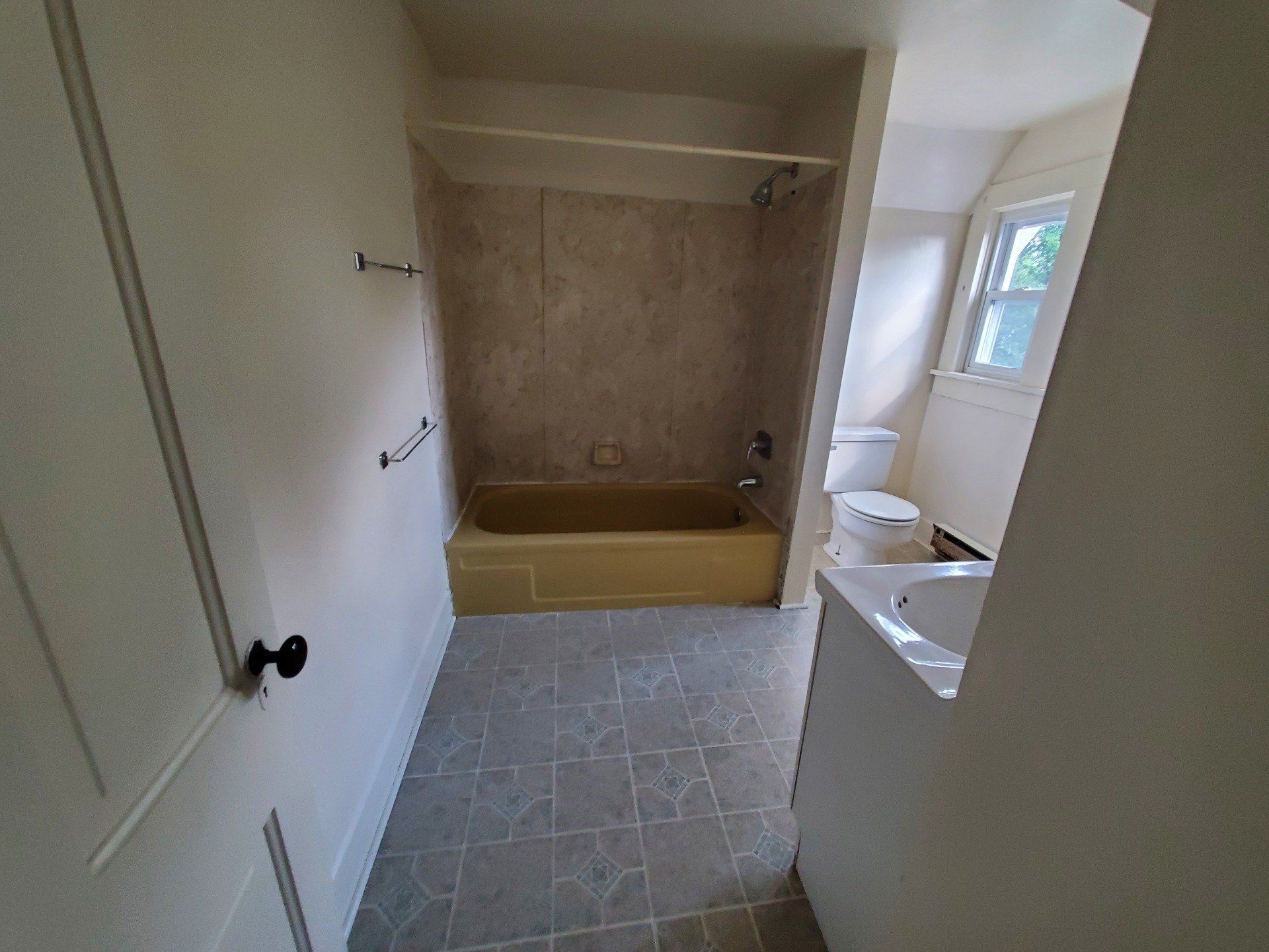 Bathroom with sink, toilet, and tub with shower