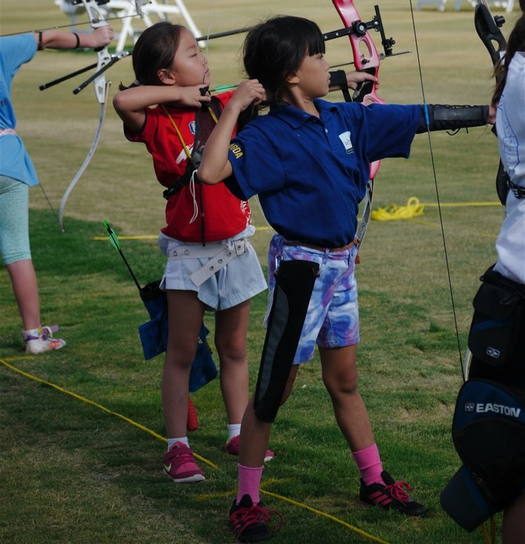 boy and girl in archery competition