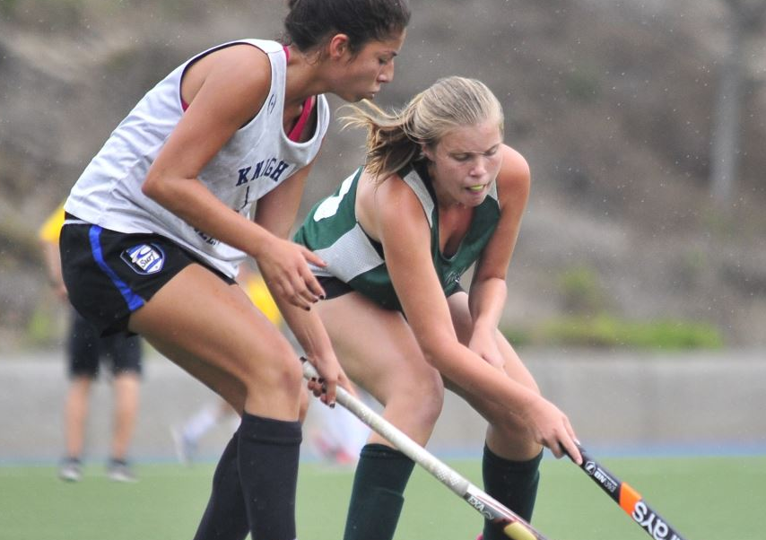 ice skating team watches teammate receive torch