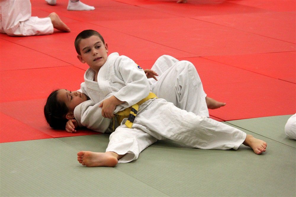 boy pins another boy in judo match