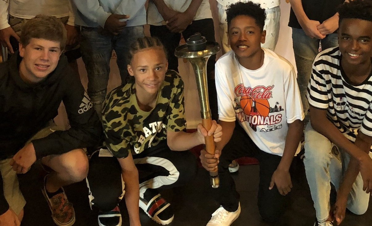 young boys holding torch