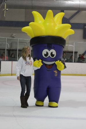 girl on ice rink with a torch mascot