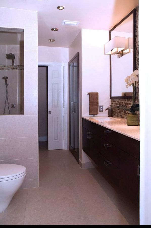A bathroom with a toilet a sink and a mirror
