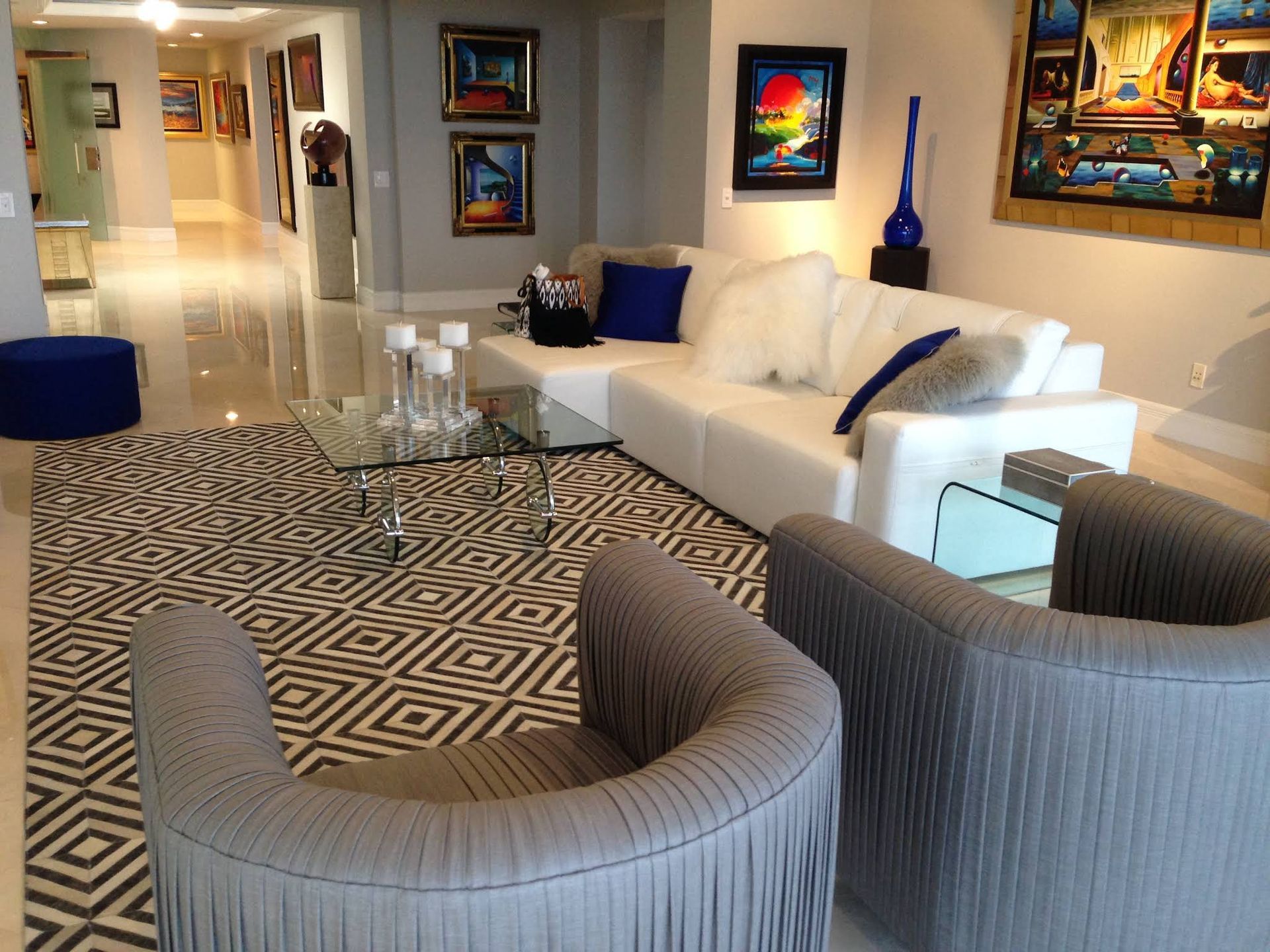 A living room with a couch and two chairs