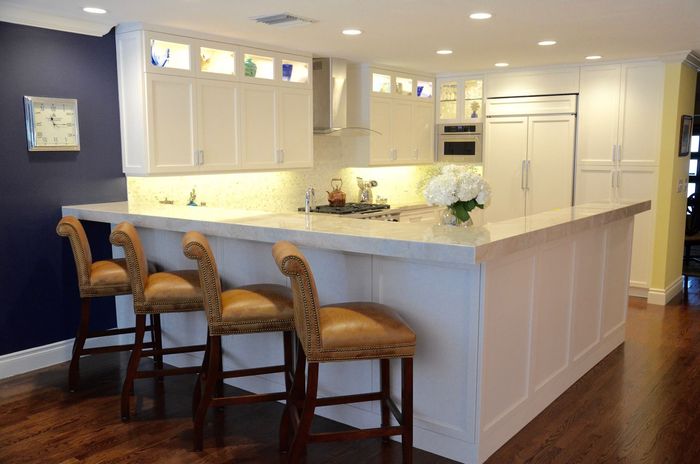 A kitchen with a large island and stools