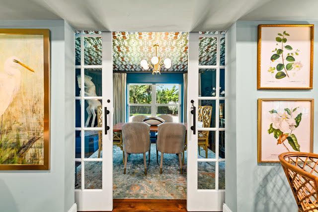 A living room with french doors leading to a dining room.