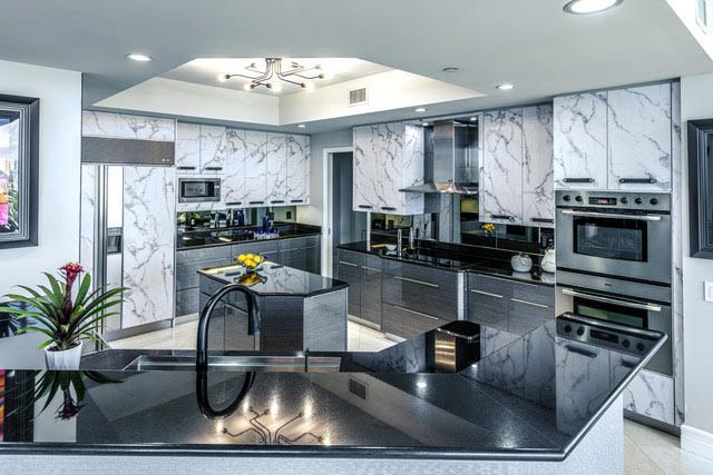 A kitchen with marble cabinets and stainless steel appliances