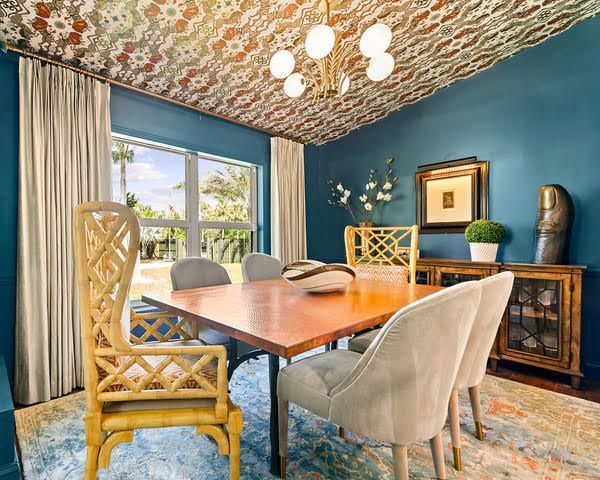 A dining room with a table and chairs and a chandelier.