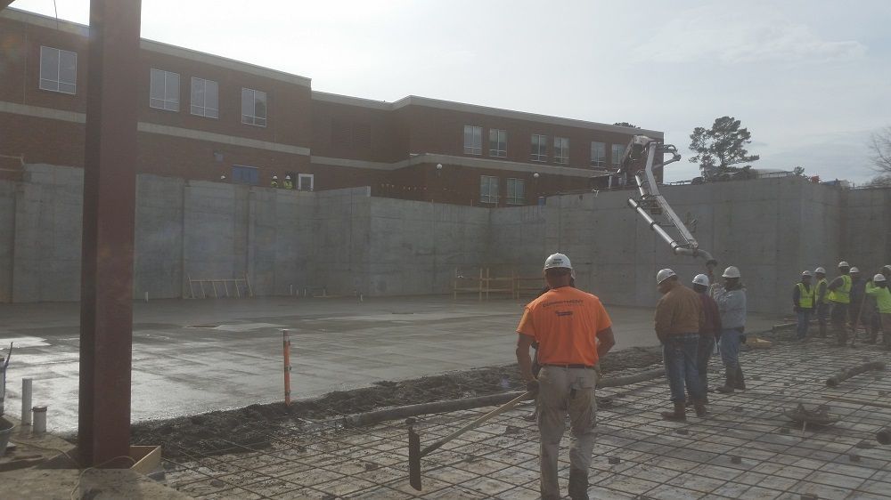 A group of construction workers are standing in front of a building.