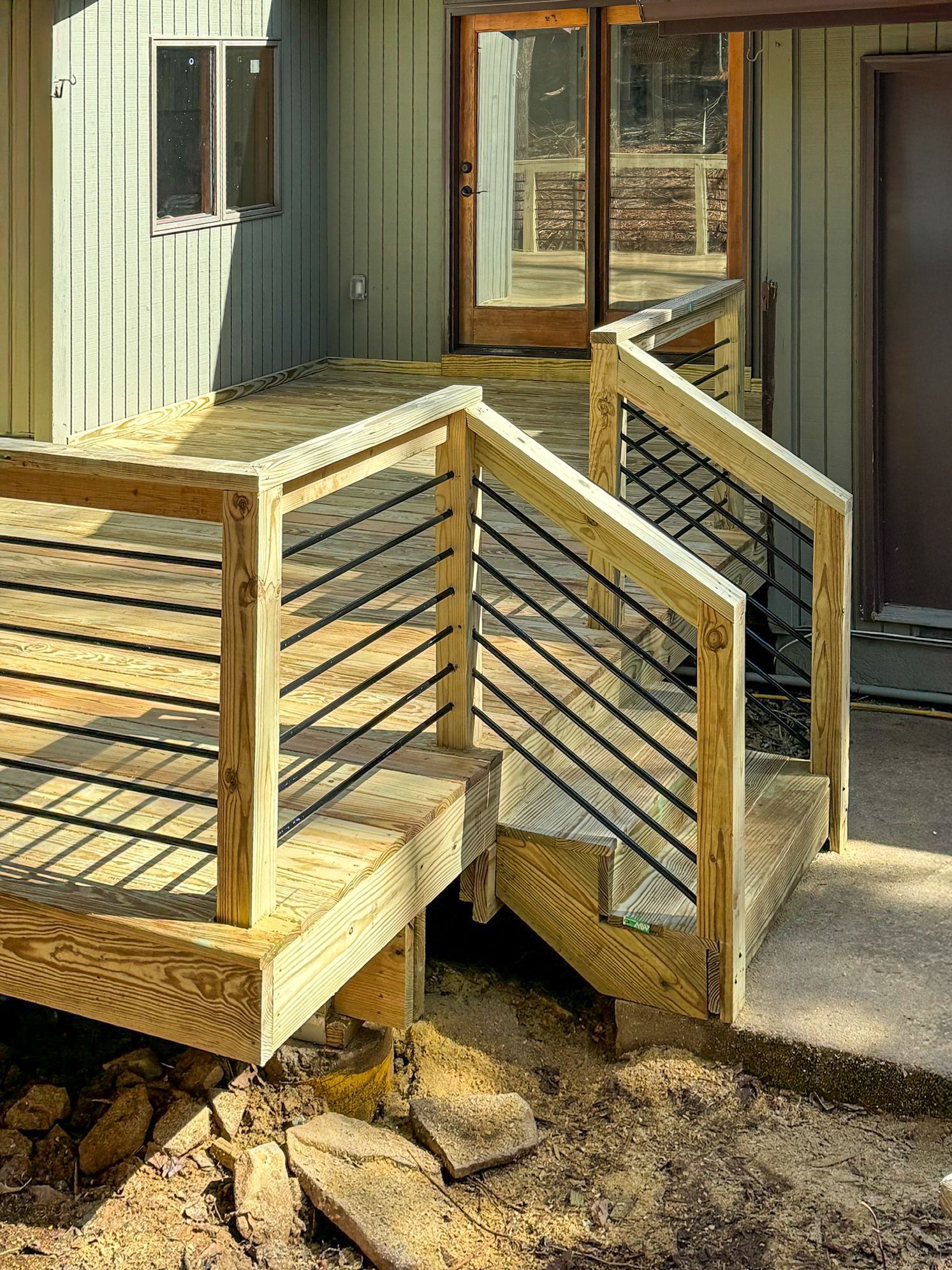 A wooden deck with stairs leading up to it