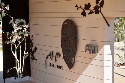 קיר עם פסל של פני גבר והשנה 1942-2015