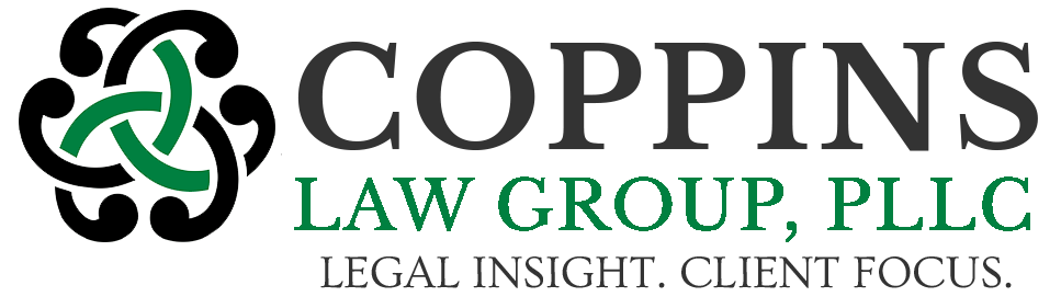 The logo for coppins law group , pllc is black and green.