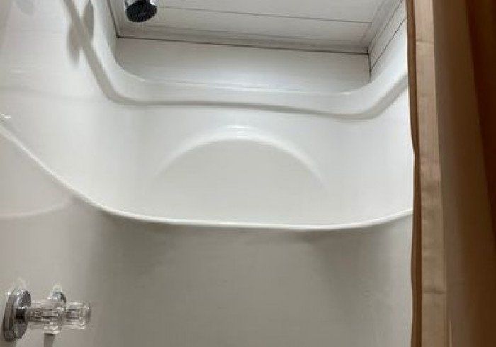 A bathroom with a shower and a bathtub.