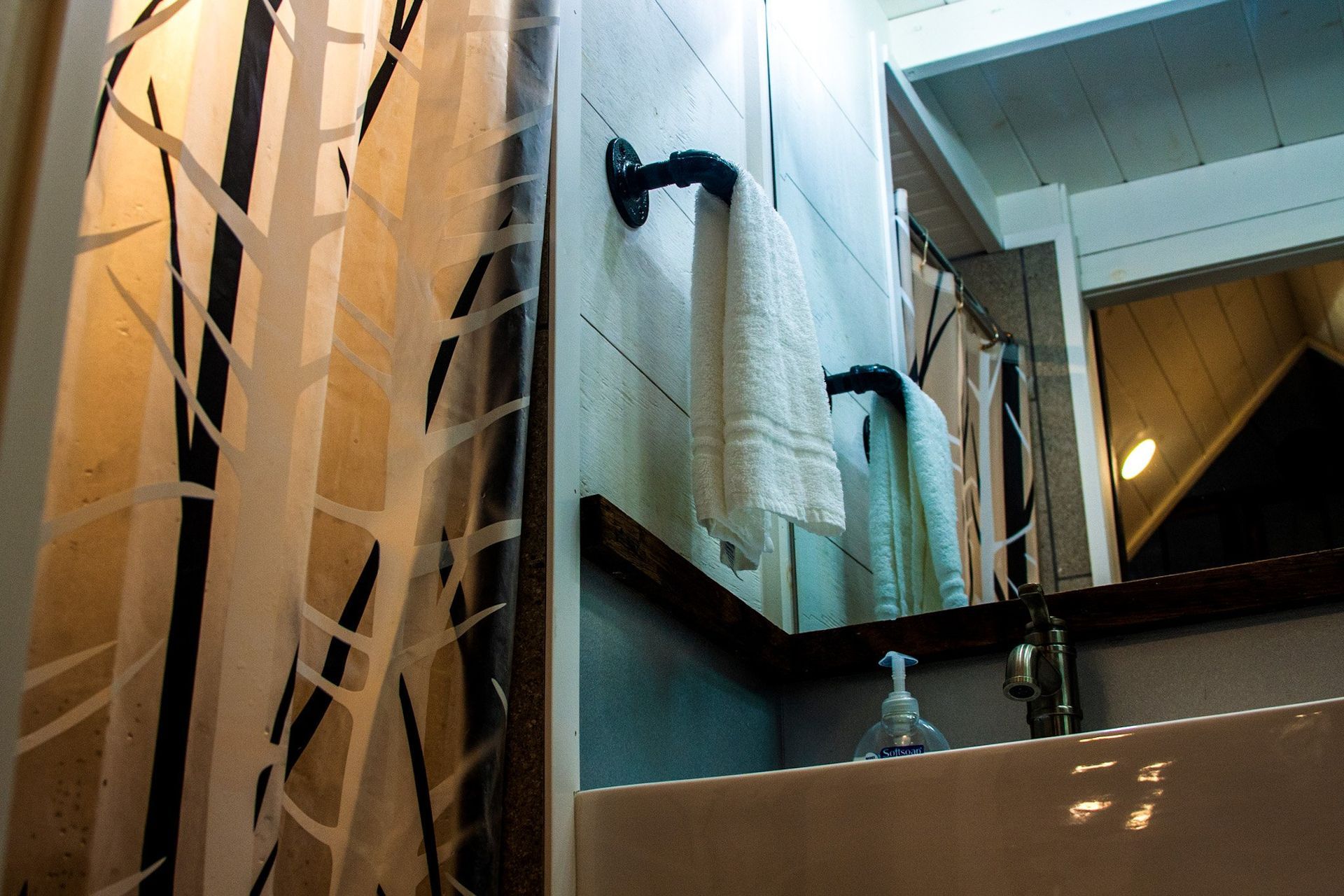 A bathroom with a towel rack and a mirror