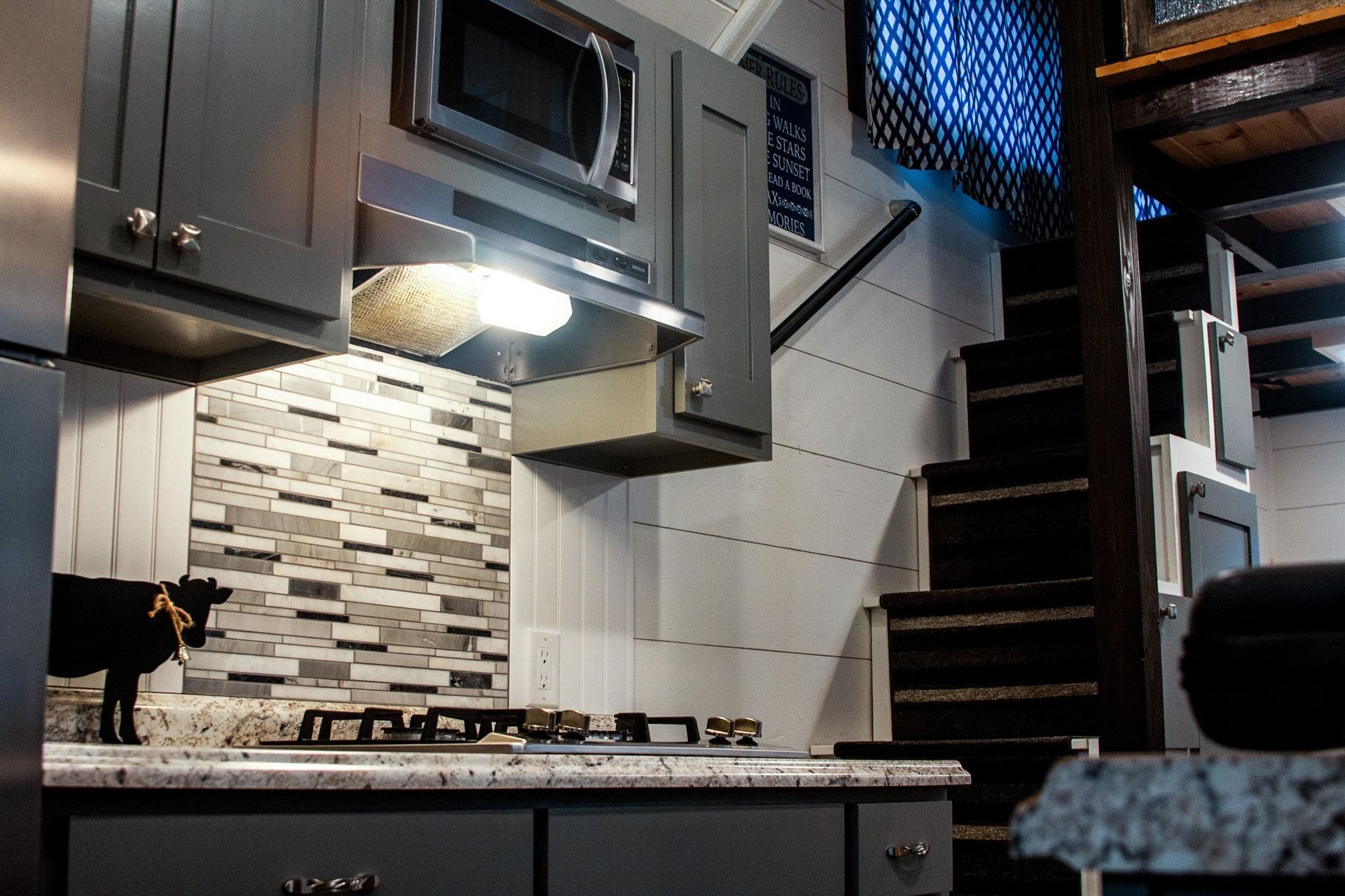 A kitchen with stainless steel cabinets and a microwave