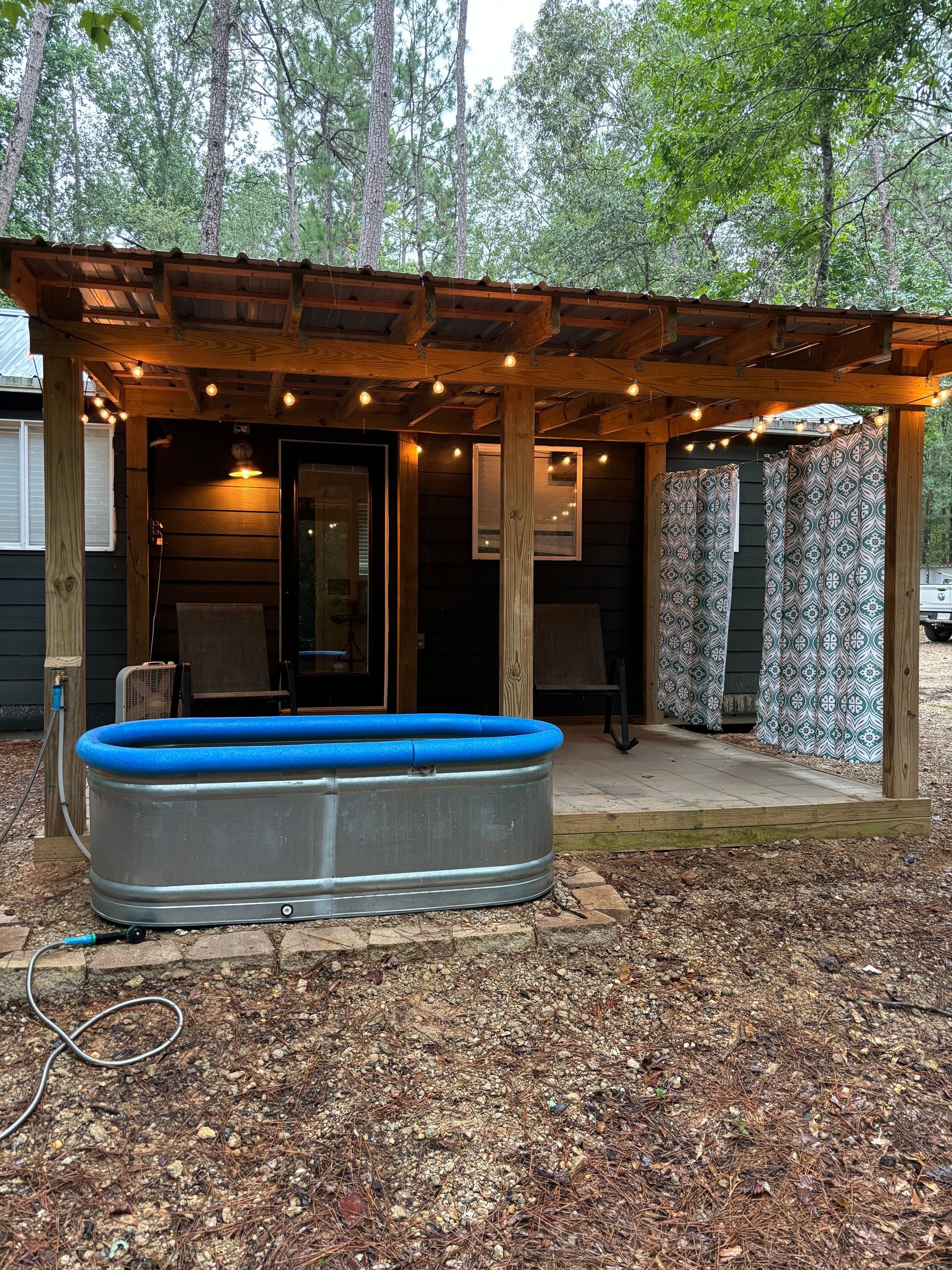 A small house with a hot tub in front of it.