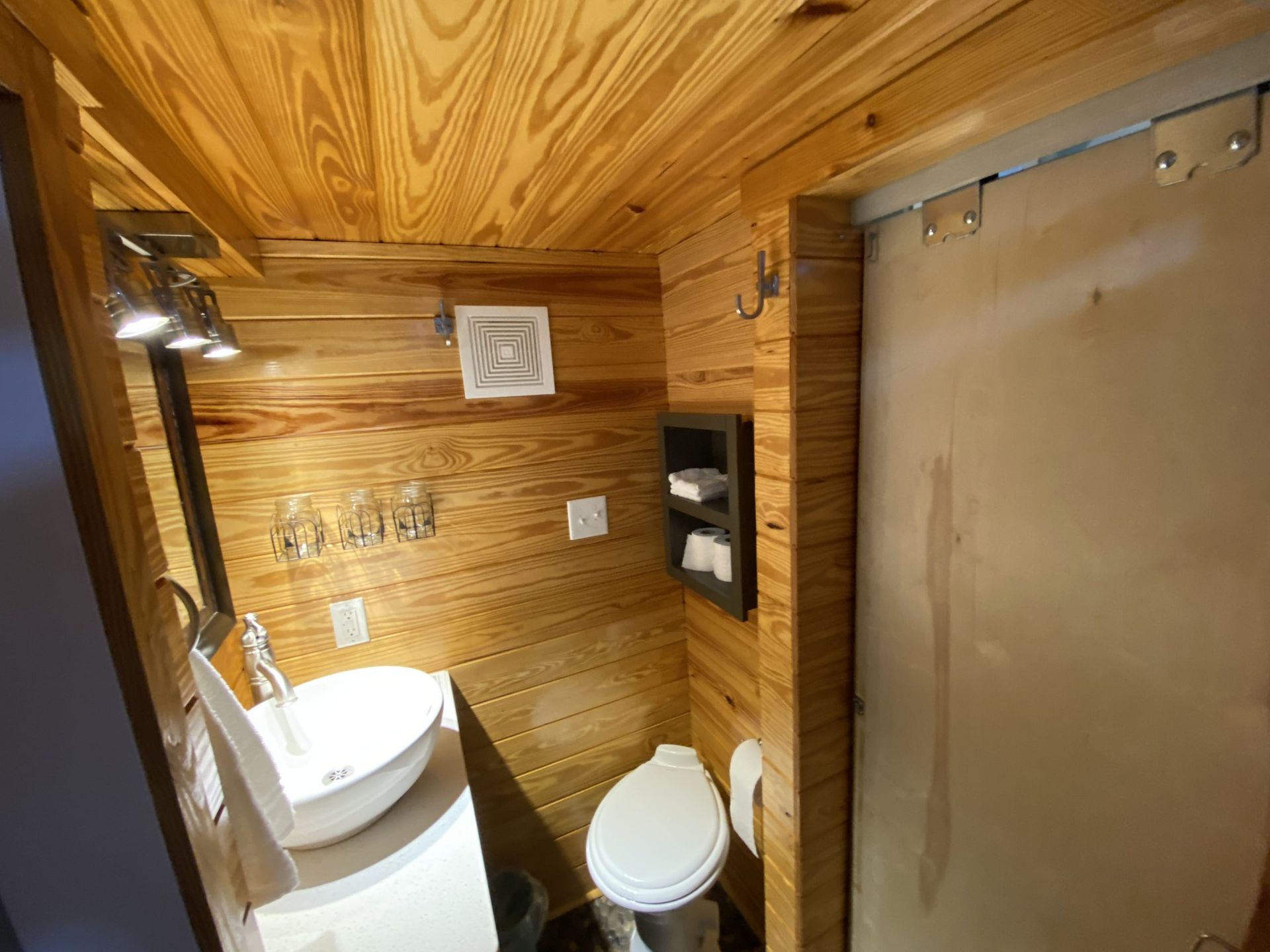 A bathroom with a toilet , sink , and shower.