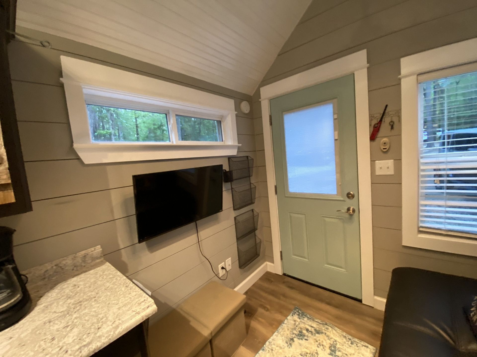 A living room with a flat screen tv mounted on the wall.