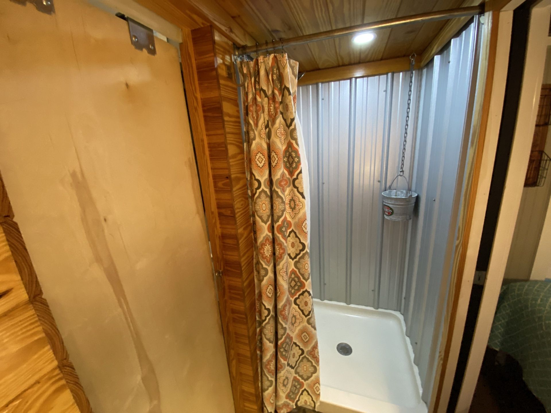A bathroom with a shower stall and a shower curtain.