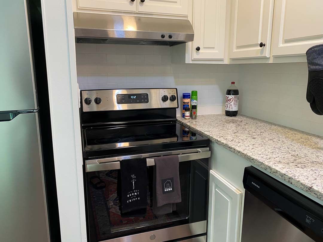 A kitchen with a stove , refrigerator and dishwasher.