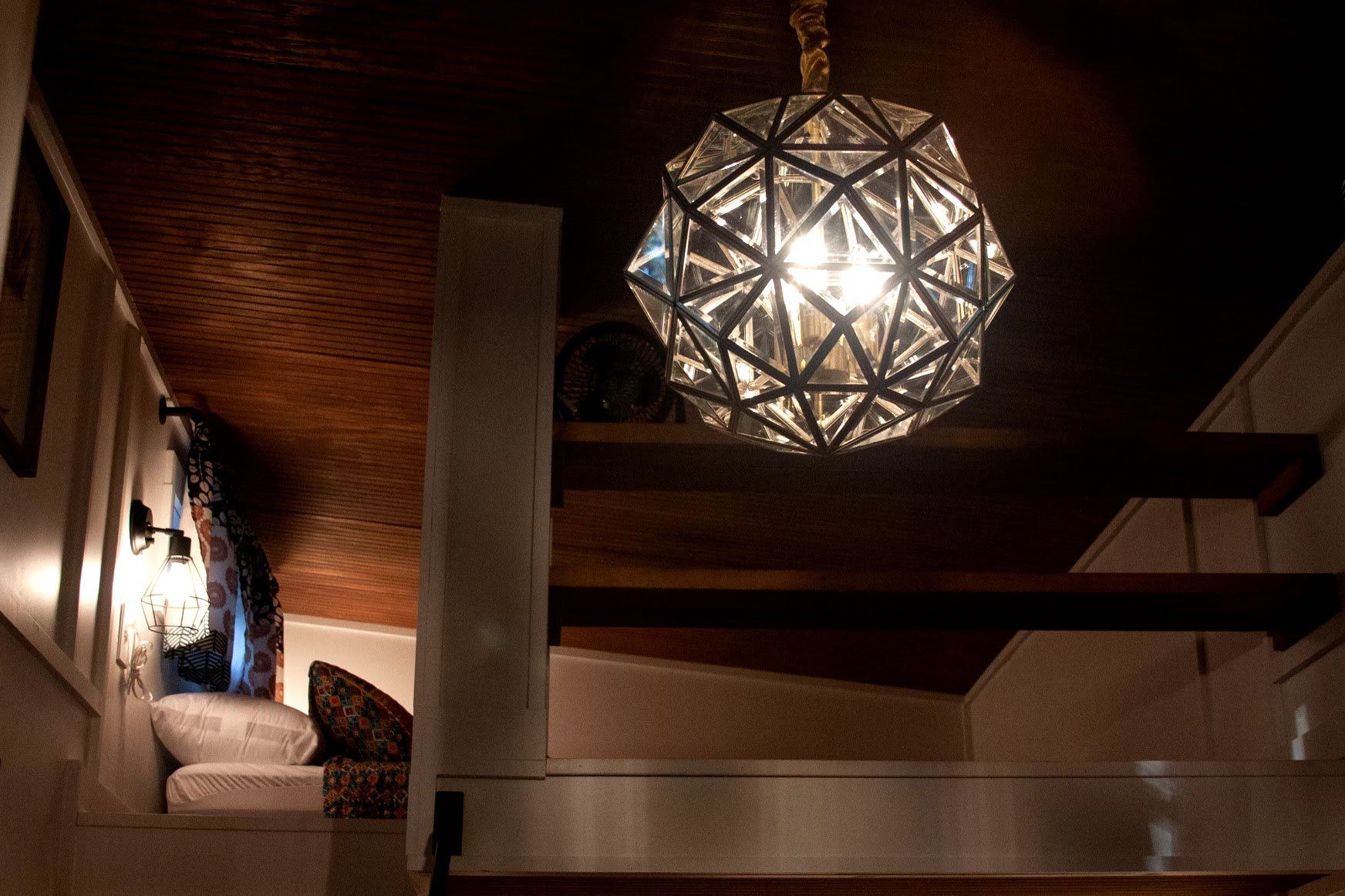 A chandelier is hanging from the ceiling of a room.