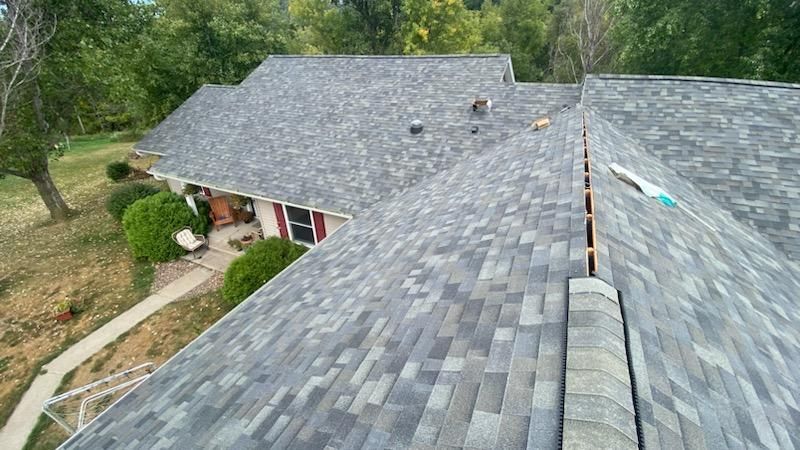 An aerial view of a house with a new roof.