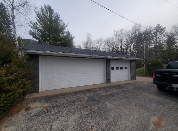 garage with new roof and siding installed by Curti Construction