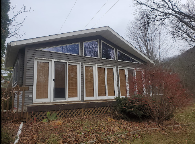 back of house that has new siding and roof installed by Curti Construction 