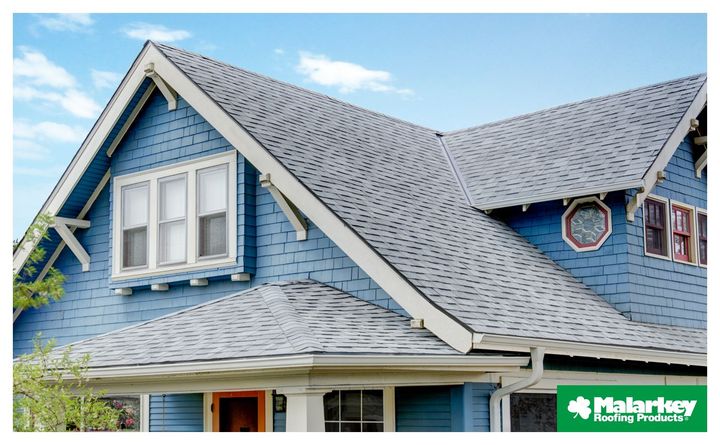 A blue house with a white trim and a new residential gray roof