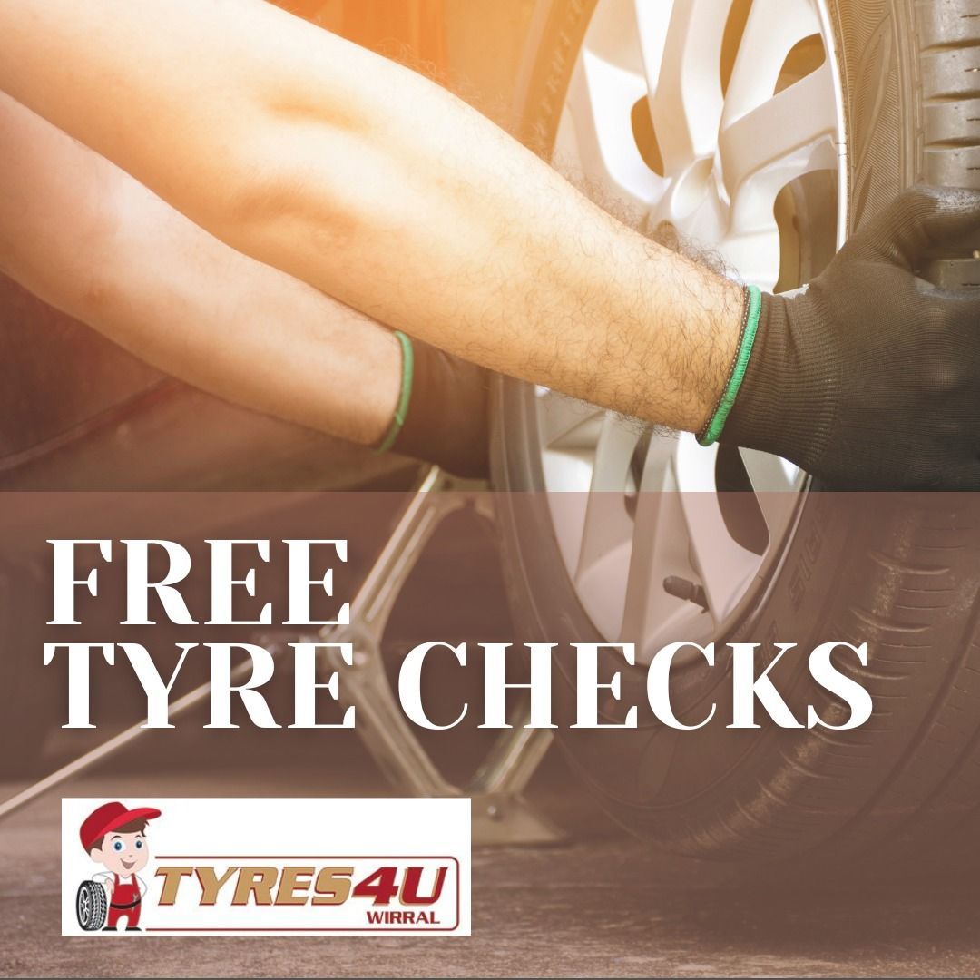 A person is changing a tire with the words free tyre checks