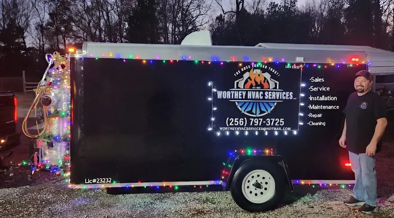 White house exterior with AC unit, white gutters, and small shrubbery.