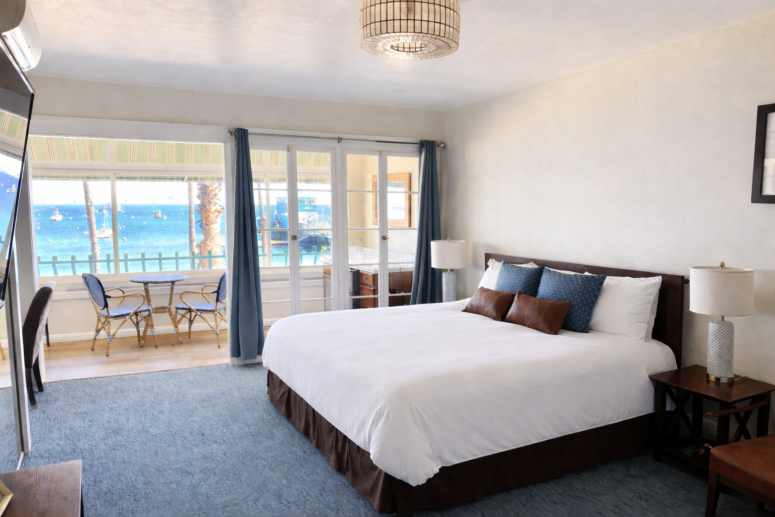 a hotel room with a king size bed and panoramic views of the bay.