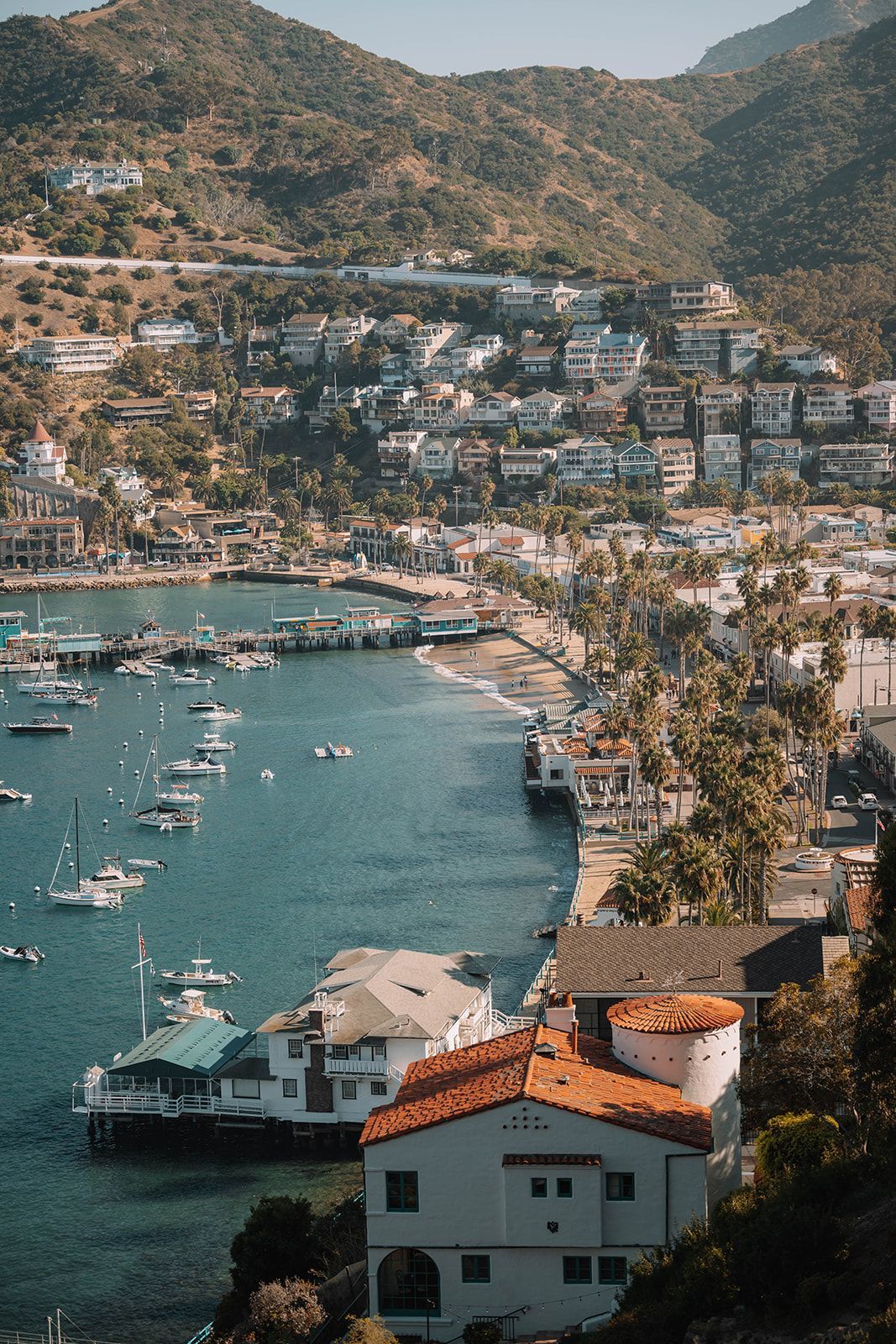 an aerial view of a small town surrounded by water and mountains .