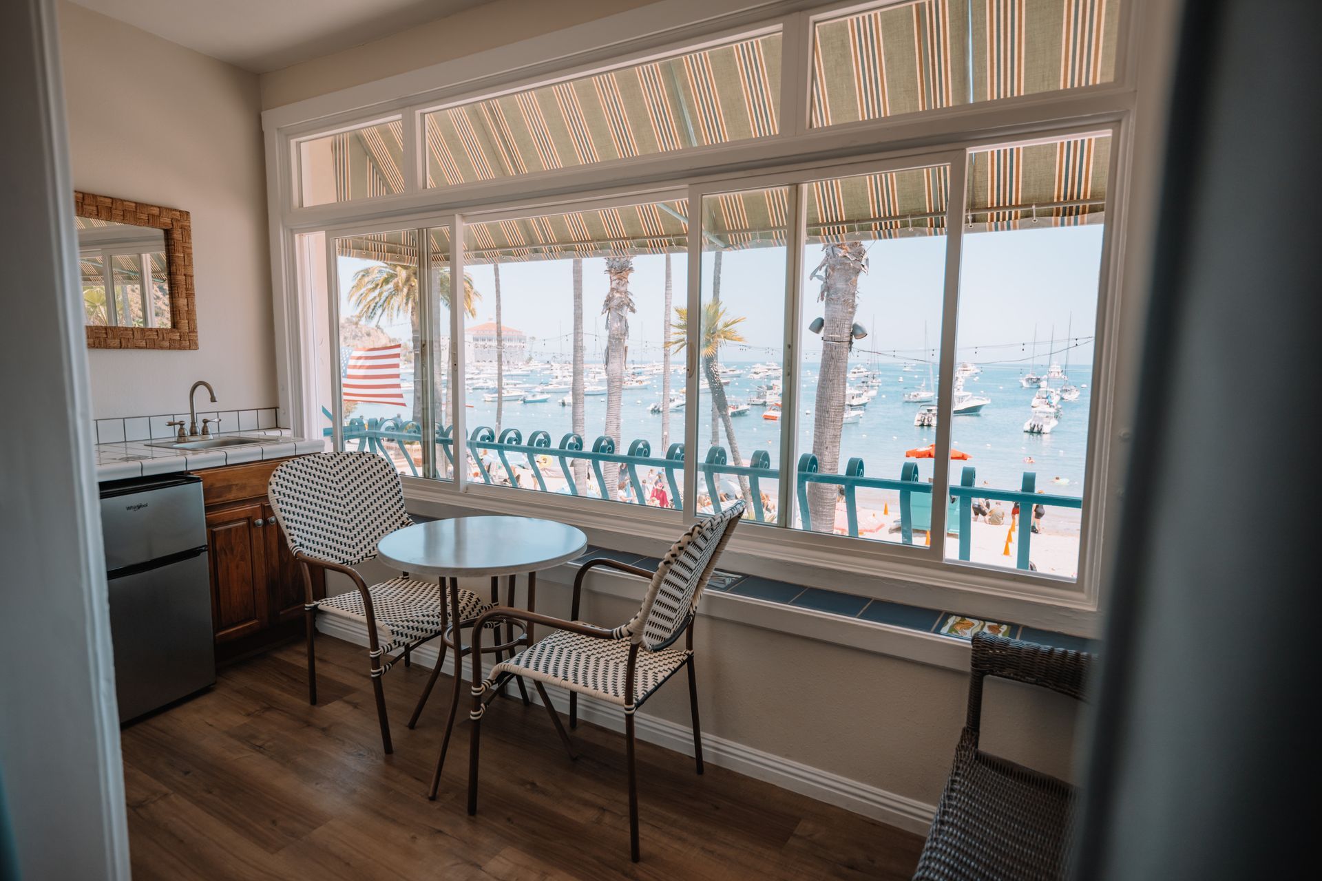 a hotel room with a queen size bed and views of the bay.