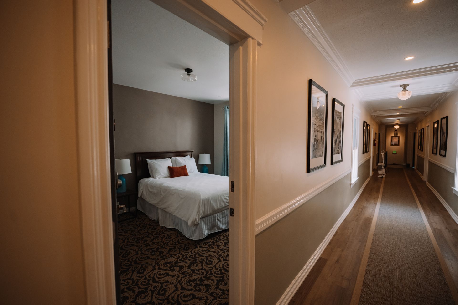 a hotel room with a queen and twin bed and a flat screen tv .