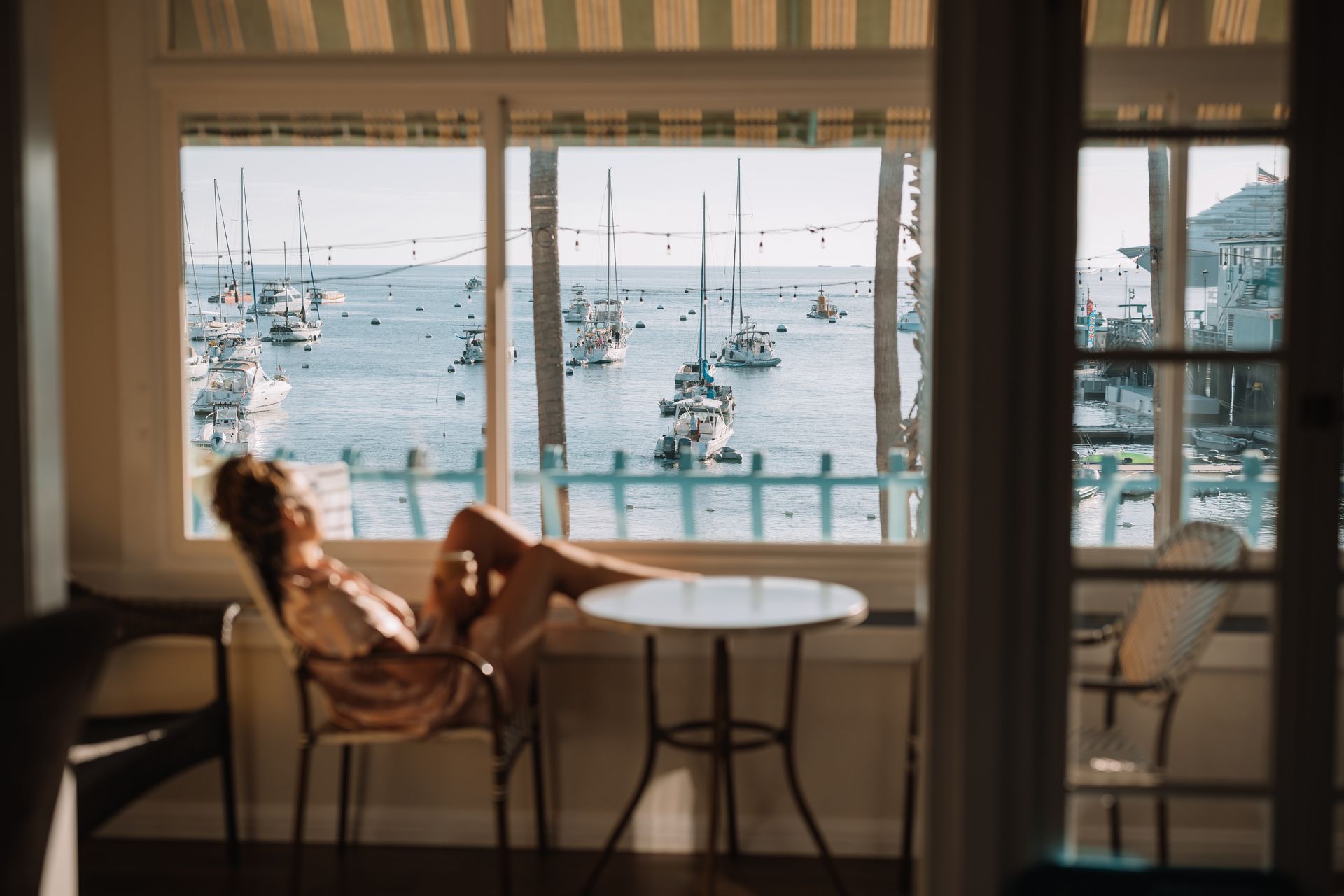 a hotel room with a king size bed and panoramic views of the bay.