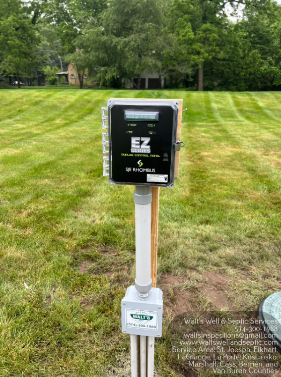 Septic system control panel mounted on a post in a grassy yard in Elkhart Indiana
