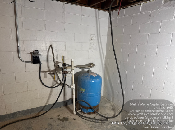 Green septic tank cover in lawn with vent pipes and access box.