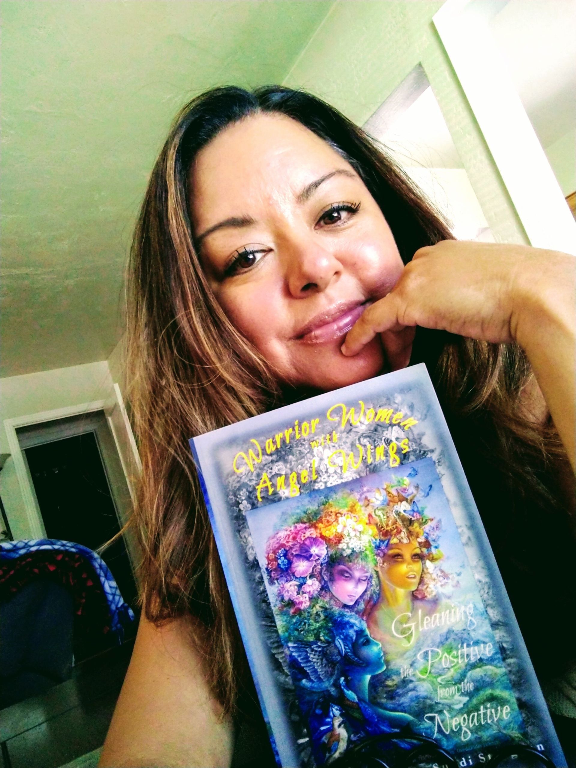 A woman is holding a book with a picture of a woman on it